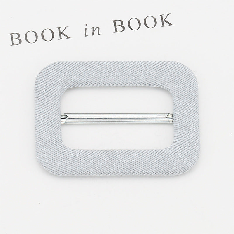 Fabric-covered D-ring buckle for belt adjustment, light gray fabric with silver metal bar