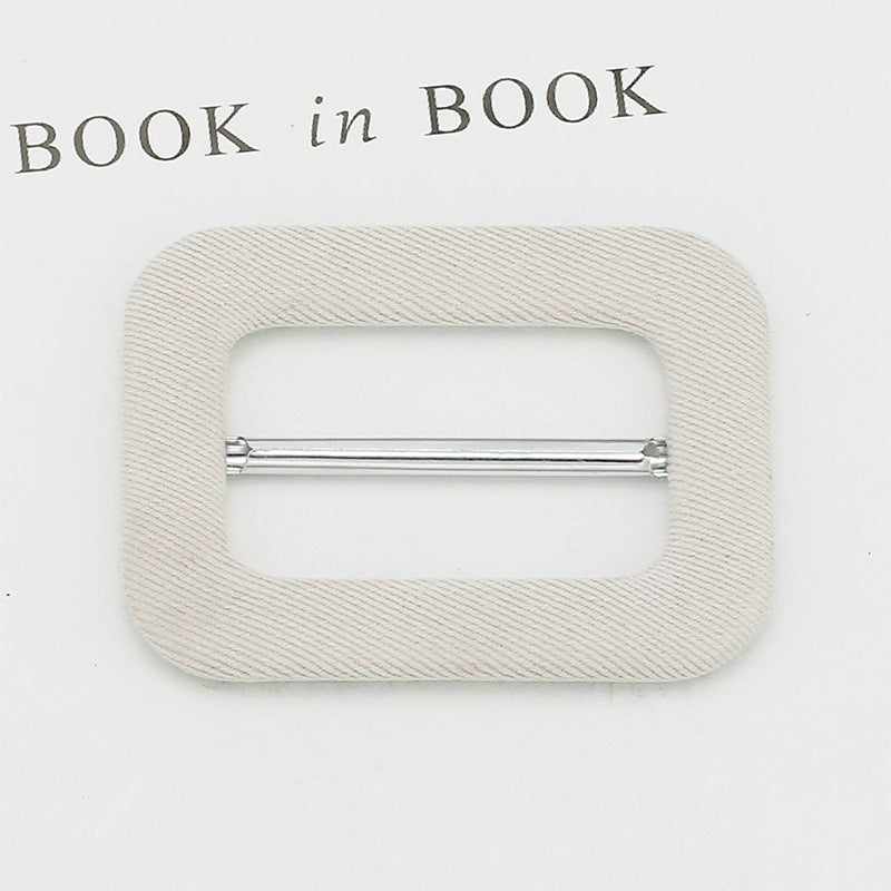Fabric-covered D-ring buckle for belt adjustment, beige fabric with silver metal bar