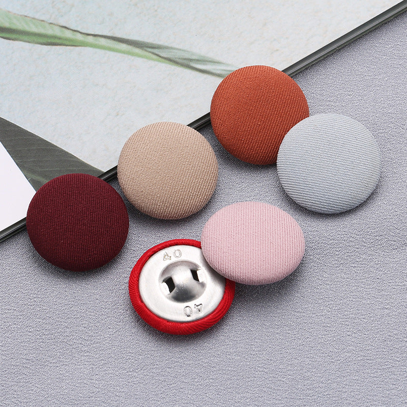 Fabric-covered shank buttons: orange, beige, maroon, pink, white, with visible metal shank