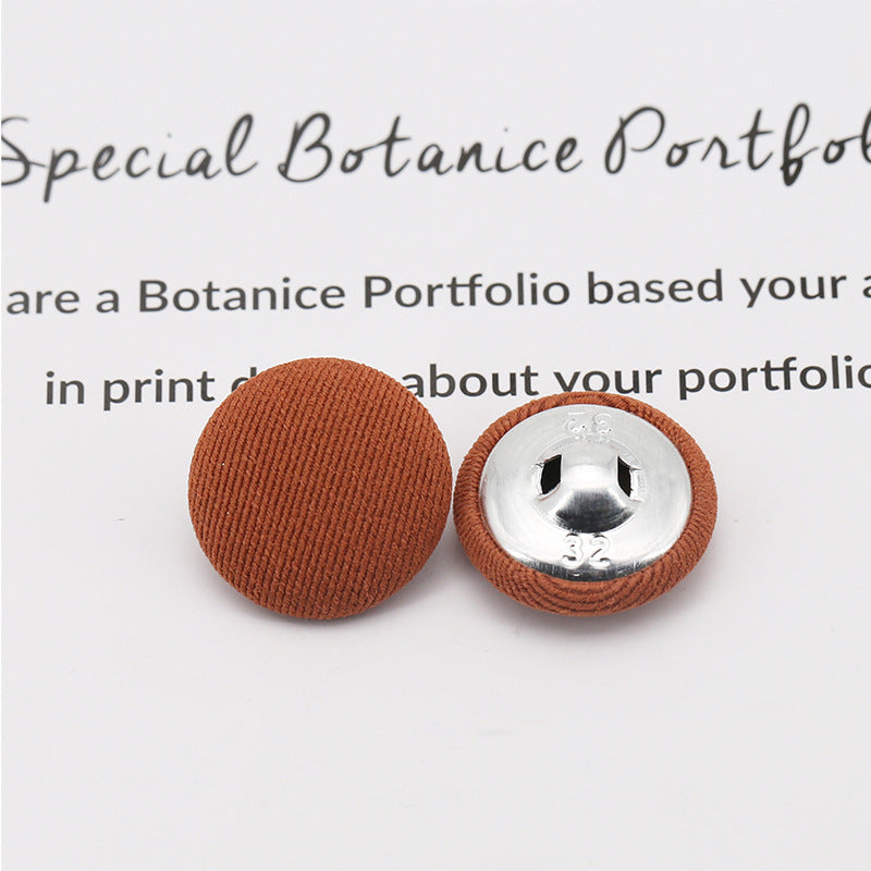 Brown fabric-covered shank buttons: round top and underside with visible metal shank