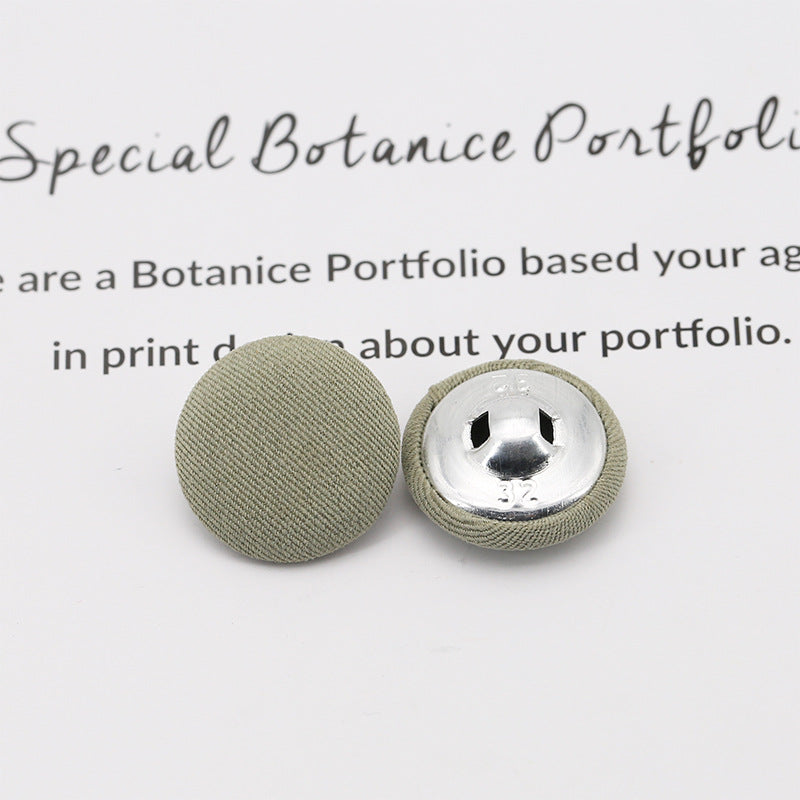 Light green fabric-covered shank buttons: round top and underside with metal shank