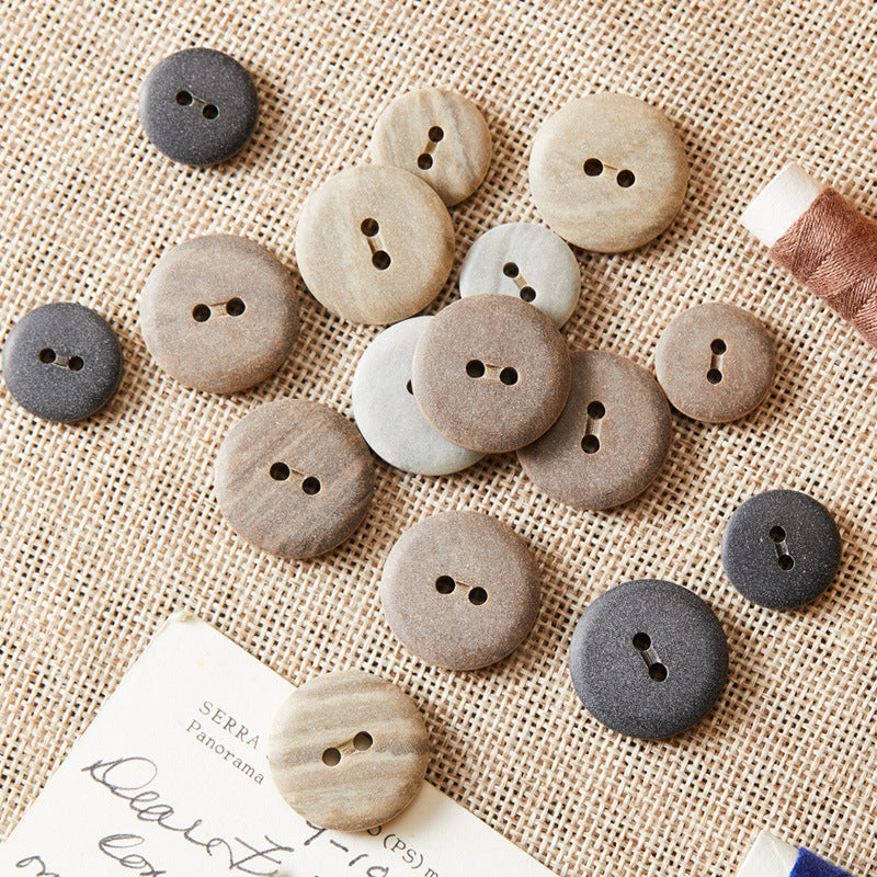 Round two-hole eco-resin buttons, mix of light grey and dark grey tones