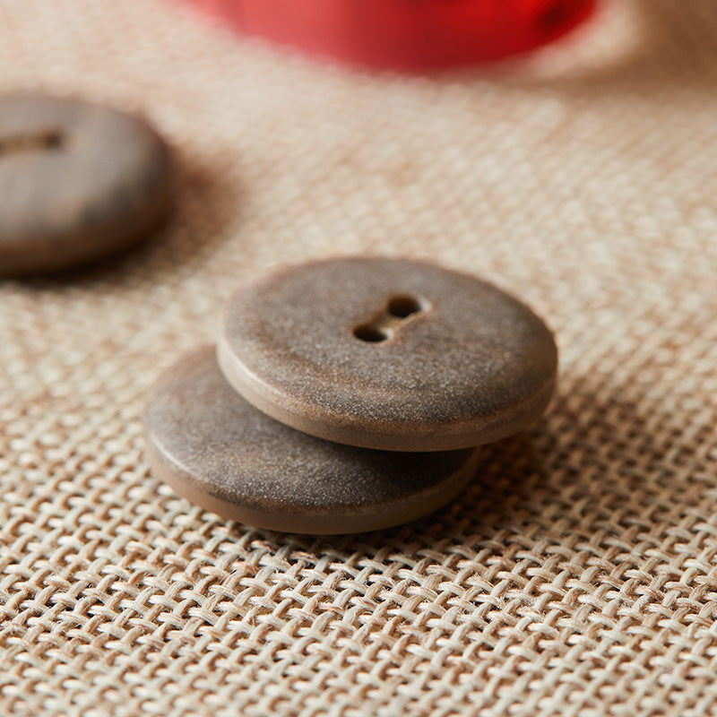 Round two-hole eco-resin button, dark brown speckled finish