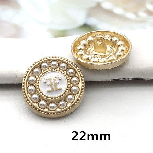 22mm gold round decorative button with pearl ring border and light letter-style center