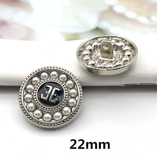 22mm silver round decorative button with pearl border and dark center letter-style detail