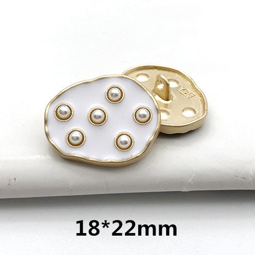 18x22mm gold-tone back with white round front, pearl dot accents and central button holes