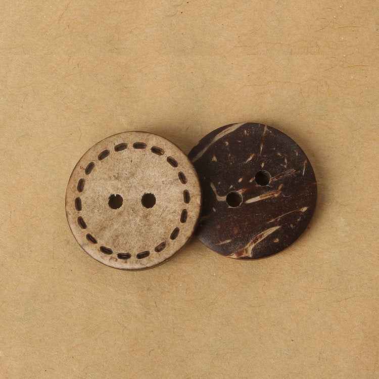 Two round 2-hole coconut shell buttons with laser dotted border, close-up view