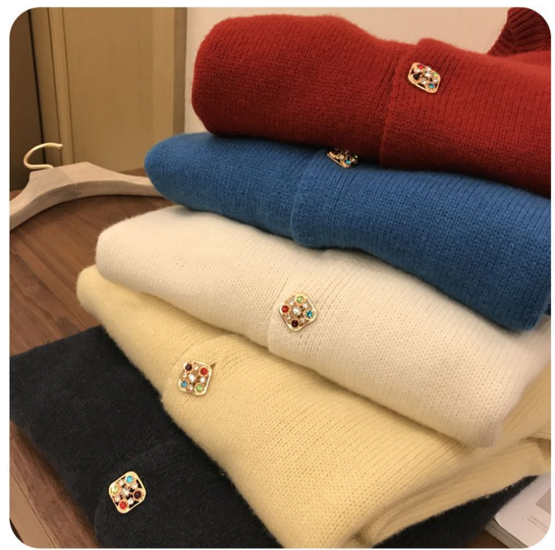 Square gemstone sweater buttons on folded knit sweaters, small multicolor stone designs