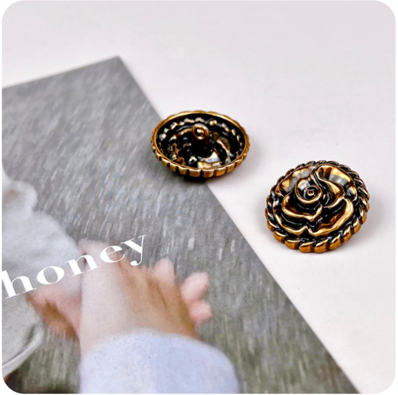 Rose-shaped metal shank buttons, vintage gold with dark inlay, ornate floral relief