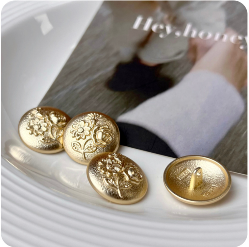 Set of gold embossed three-flower metal shank buttons, round with raised detail