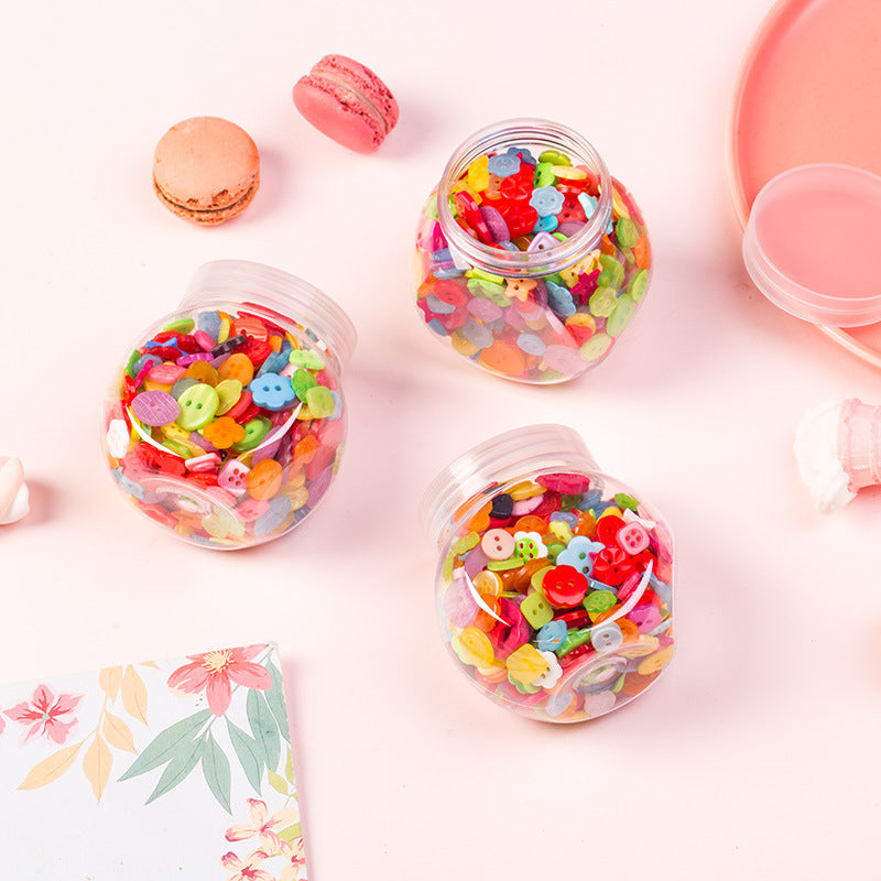 Three clear button bottles with candy-colored buttons, assorted shapes and colors.