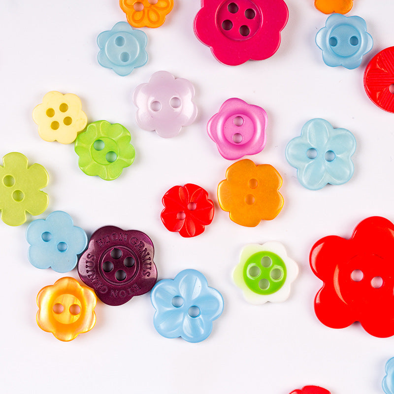 Assorted craft buttons, candy colors, flower and star shapes with 2–4 holes.
