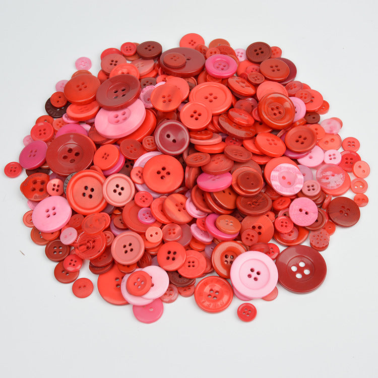 Red and pink resin craft buttons pile with round 4-hole designs