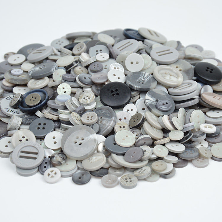 Gray and white resin craft buttons pile with mixed 2-hole and 4-hole designs