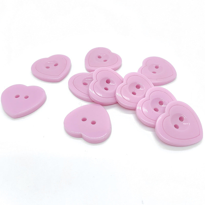 Assorted pink heart-shaped resin buttons with two holes, mixed angles