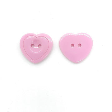 Pink heart-shaped resin craft button with two holes, glossy front view
