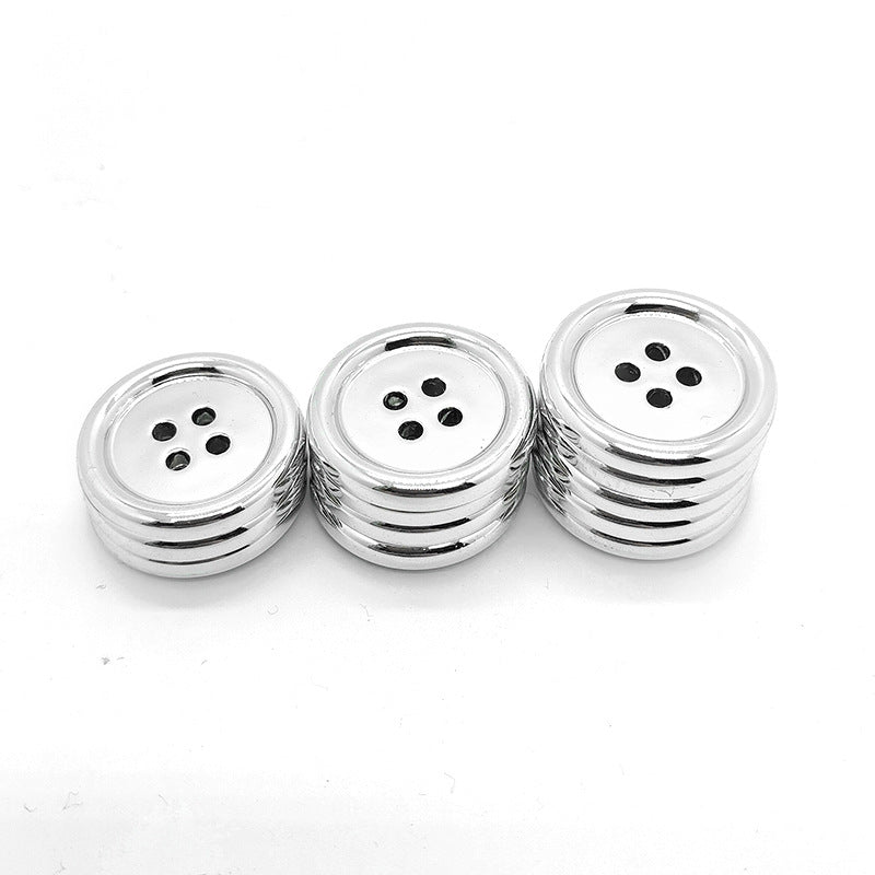 Stacked round 4-hole plastic buttons with silver electroplated edge detailing