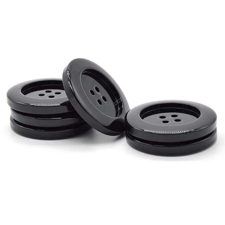Pack of glossy black round resin buttons, four-hole design, side views (6pcs)