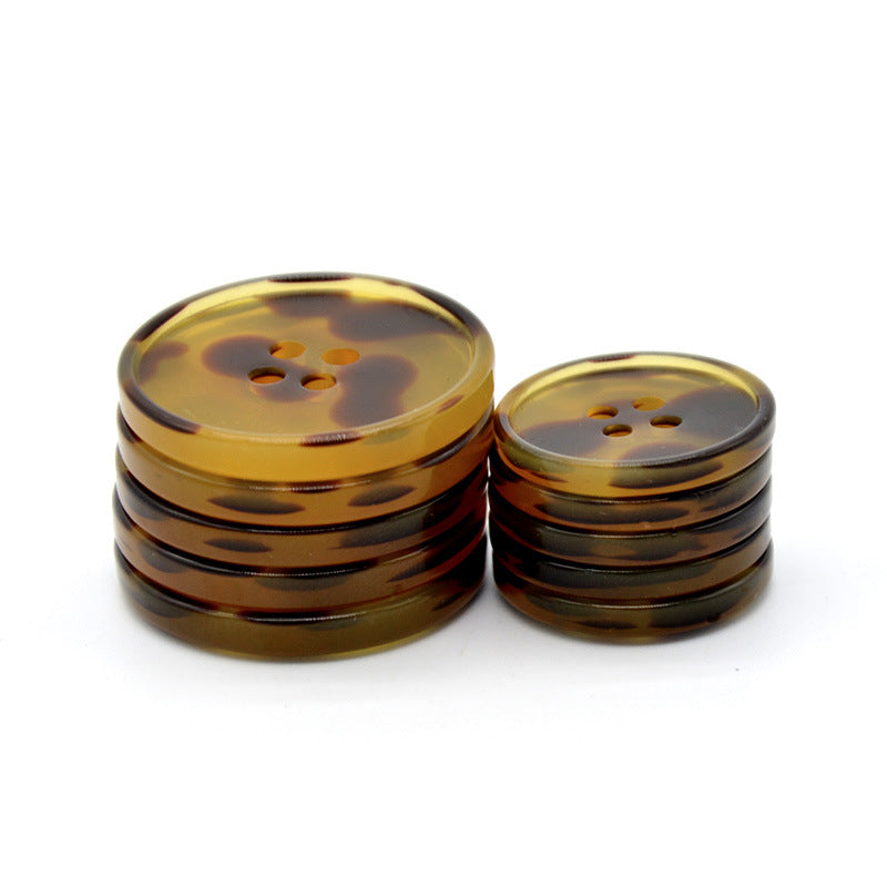 Stacked round brown leopard resin buttons with four-hole fronts; 30/40L size