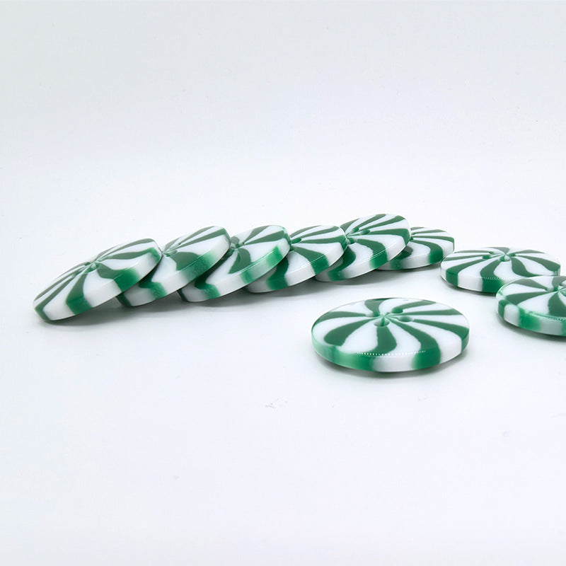 Side view of green-and-white windmill resin buttons, round, 1 inch, 2-hole