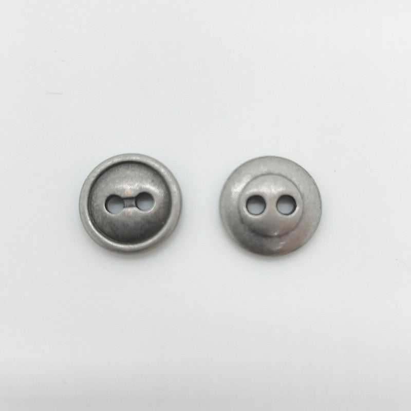 Antique silver round 2-hole button, zinc alloy, close-up (pair shown)