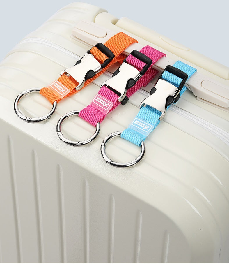 Four add-a-bag luggage straps in orange, pink, light blue on suitcase