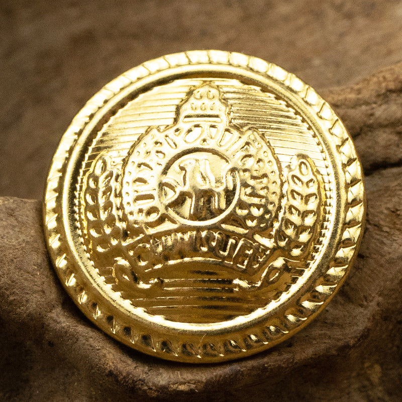 Gold metal shank button, close-up front with crown emblem and ridged rim