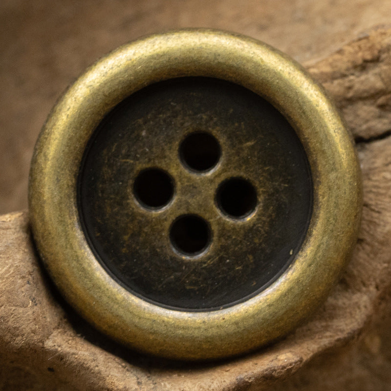 Round 4-hole metal button with brushed bronze finish and four holes
