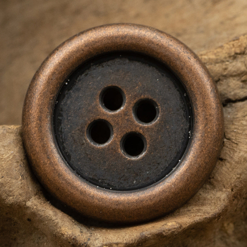 Round 4-hole metal button with antique bronze finish and four holes