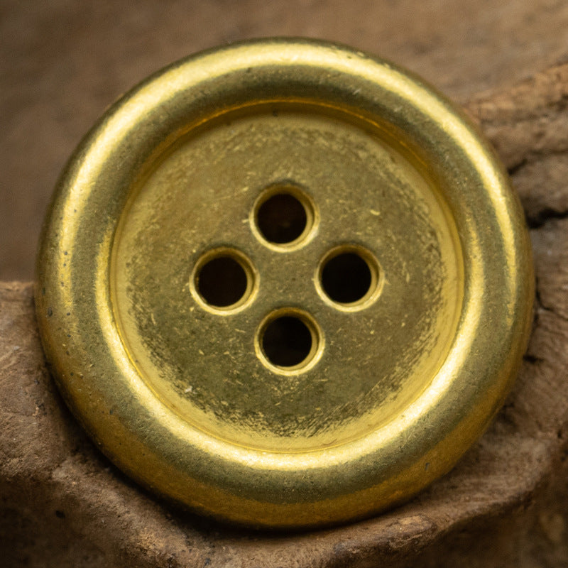 Round 4-hole metal button with gold finish and four holes