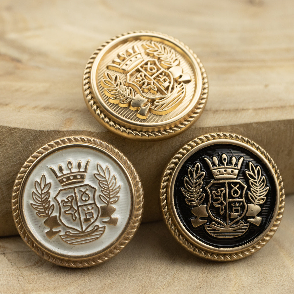 Crown and wheat crest suit buttons in gold, white gold, and black gold finishes