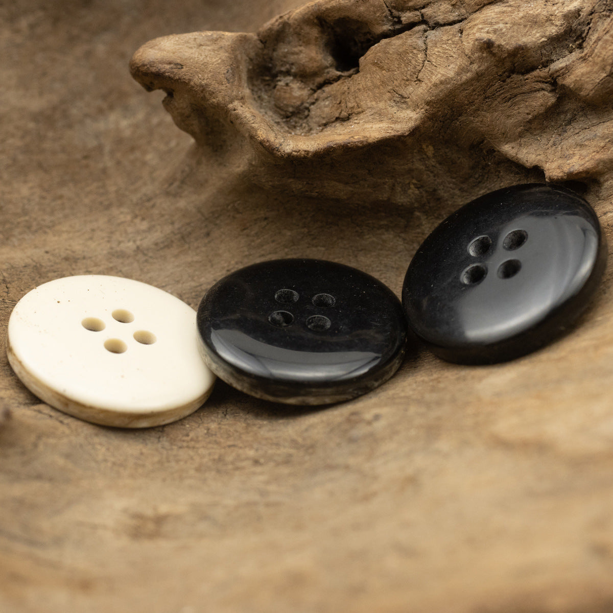 Marble-effect resin buttons, 4-hole, cream and dark gray and black.