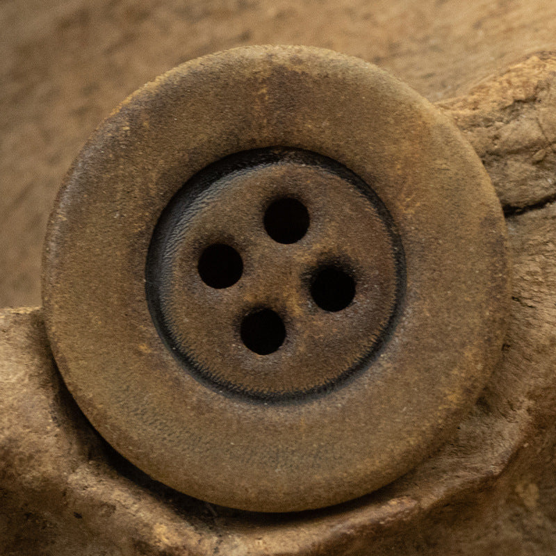 Antiqued real horn button, 4-hole front with dark rim and rustic curved finish