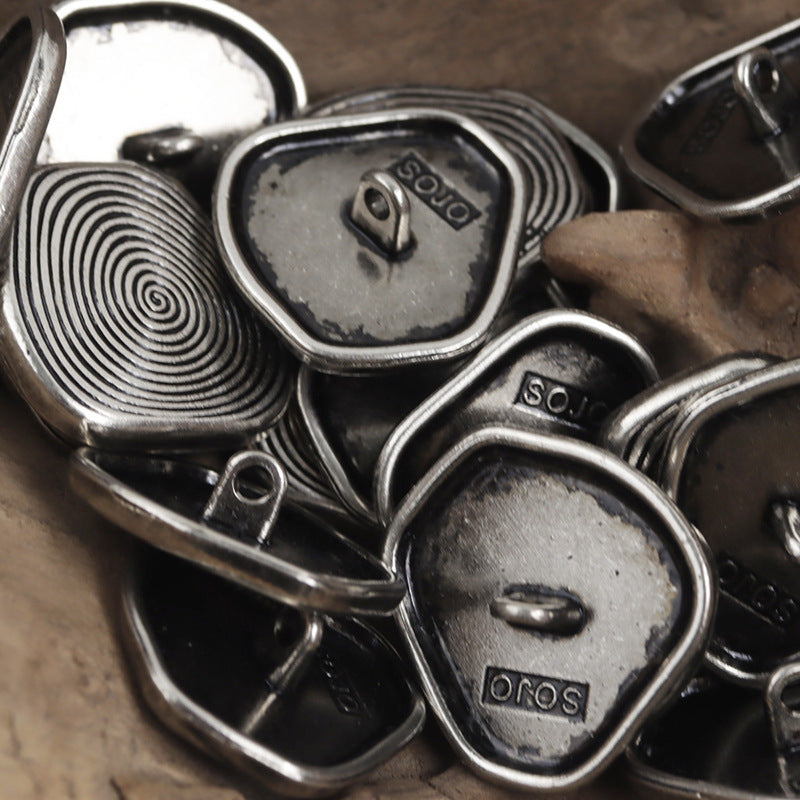 Silver metal shank buttons, oval front caps with concentric swirl pattern