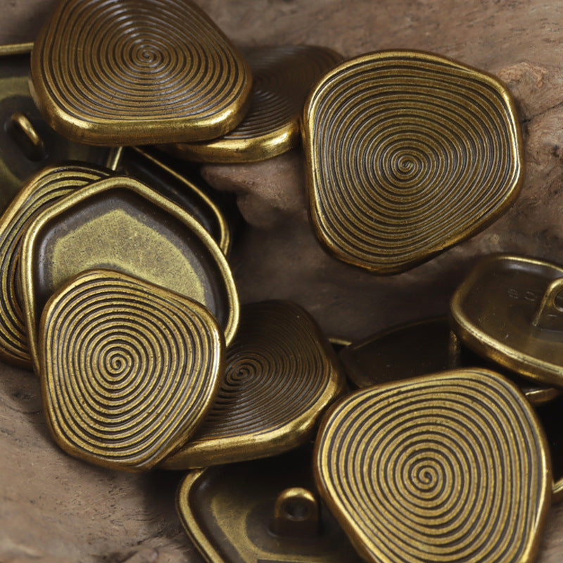Set of bronze metal shank buttons, oval caps with concentric swirl ridges