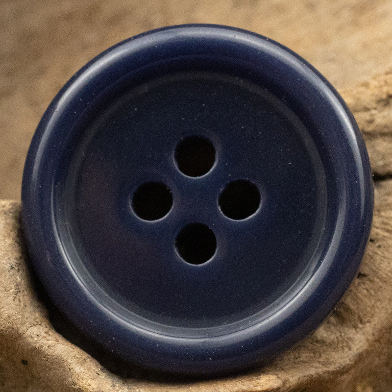 Dark navy resin suit button with four holes, solid color front