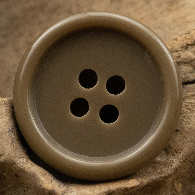 Olive-brown resin suit button with four holes, solid color front