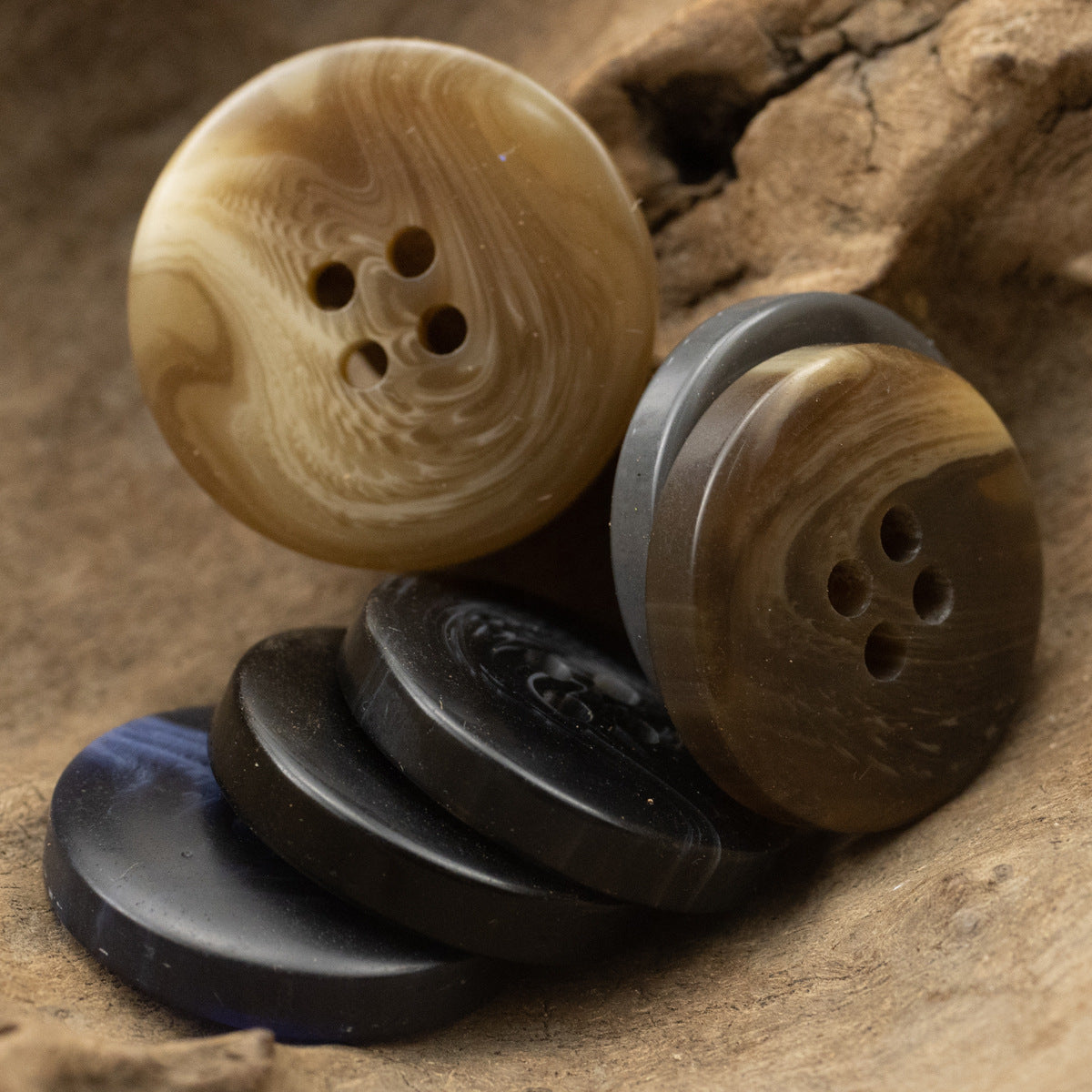 Round resin buttons set: khaki, dark gray, and black with four holes each