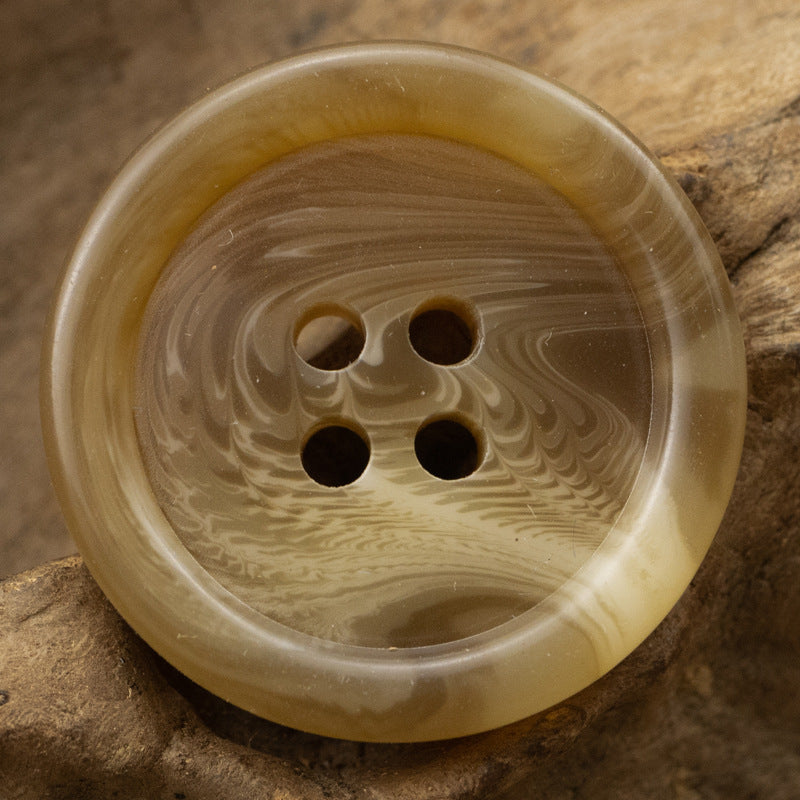 Khaki round resin button with four holes and marbled swirl pattern