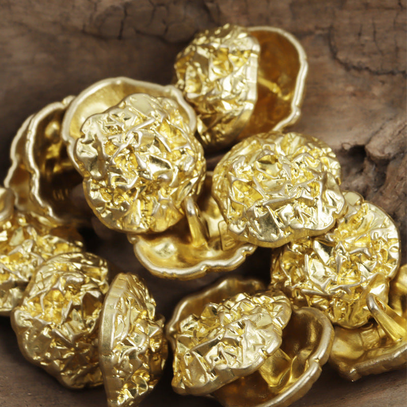 Irregular pleated metal buttons, gold tone, metal shanks on the backs
