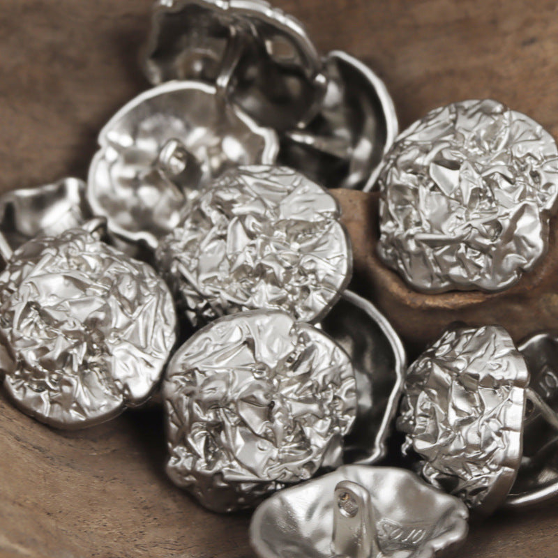 Irregular pleated metal buttons, silver tone, metal shanks on the backs