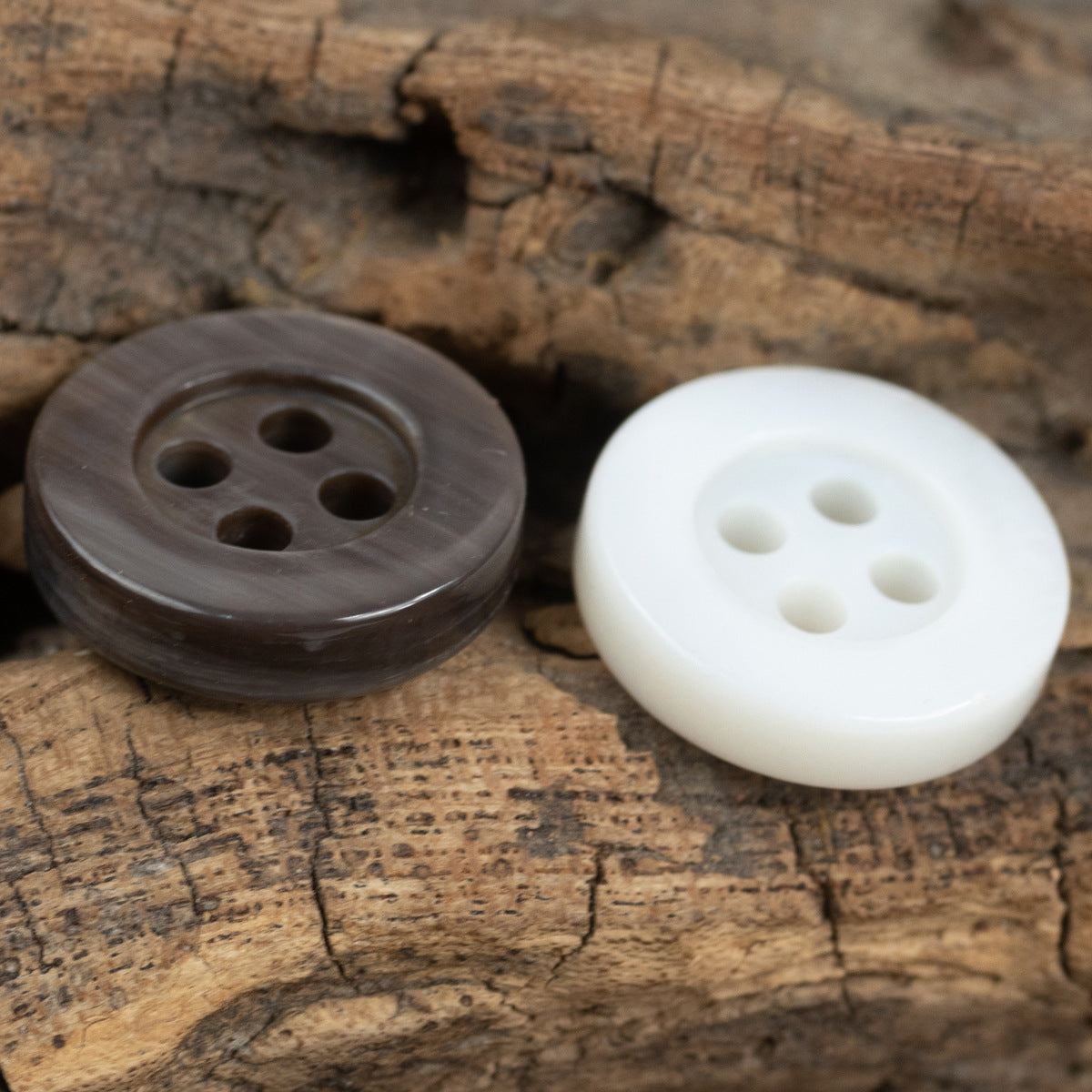Smoky gray and white pearl shell buttons, 4 holes, round pair on surface