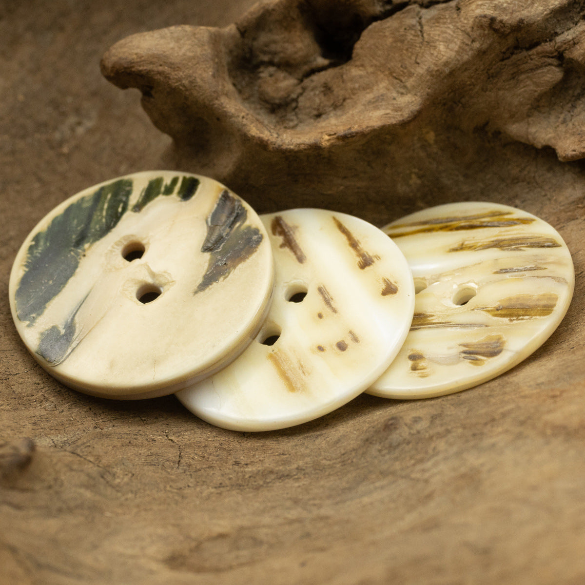 Three flat two-hole shell buttons, classic look with visible button holes