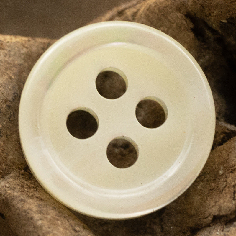 Beige 4-hole shell button front with four stitching holes