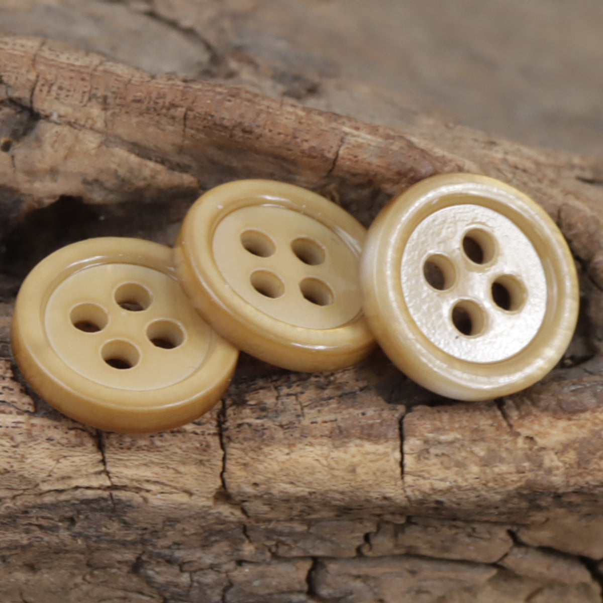 Champagne natural pearl shell buttons, round four-hole styles, raised rim (3 shown)