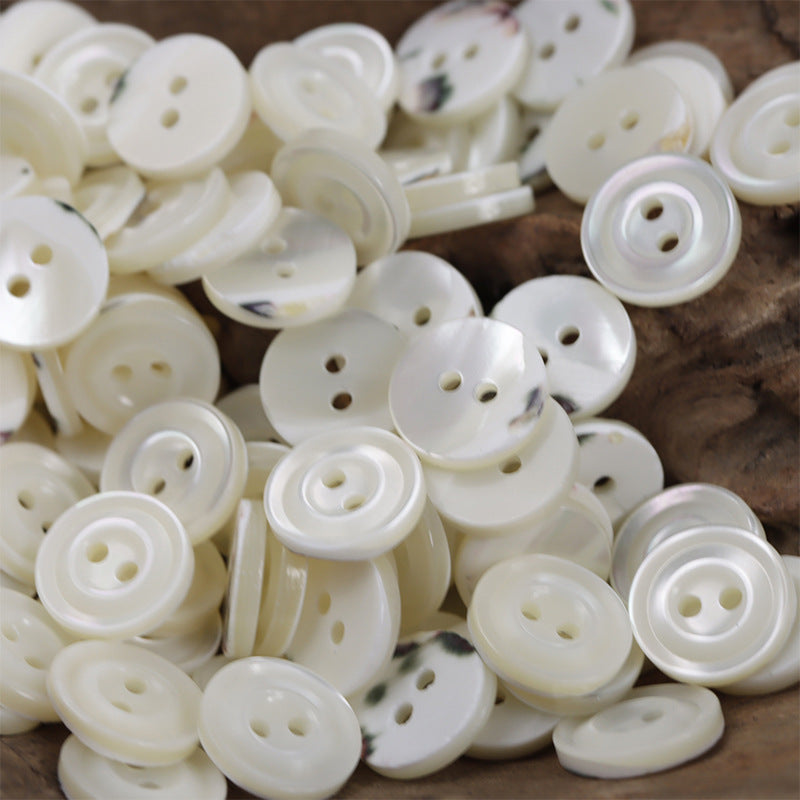 20-pack natural beige 2-hole shell shirt buttons, scattered pile, two-hole faces visible
