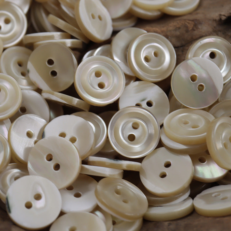 Natural beige 2-hole shell shirt buttons, close-up of mixed front and side views