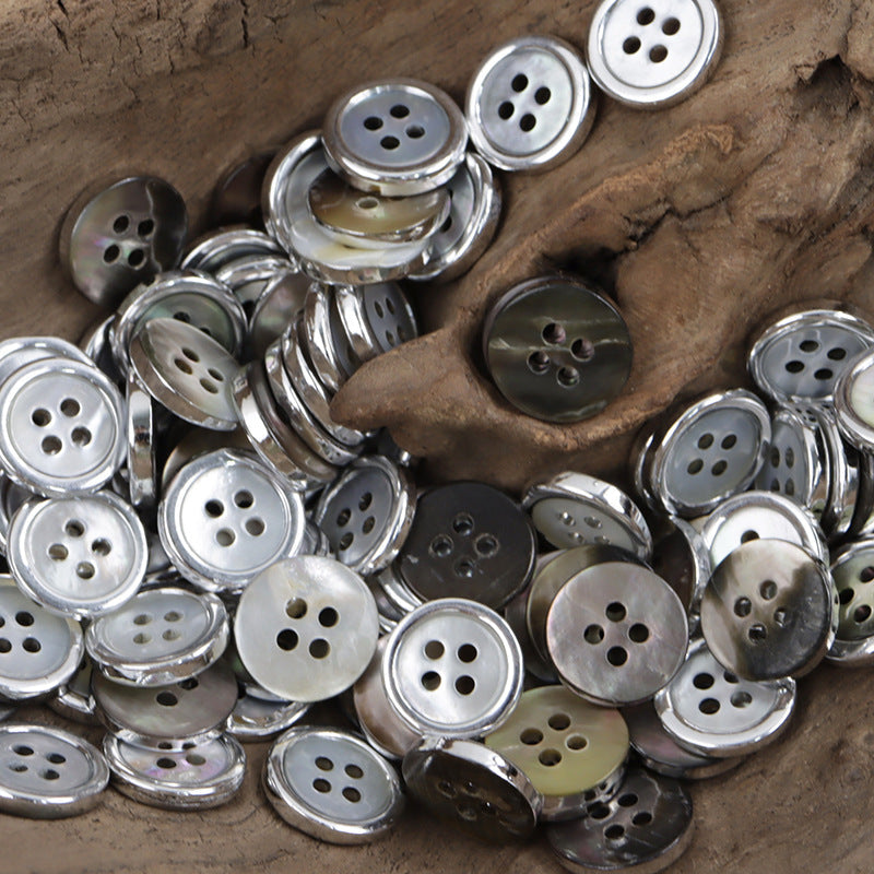 Set of silver-edged natural shell buttons, round faces with 4 holes