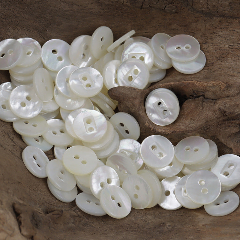 Natural white shell buttons assortment, two-hole maple leaf spiral design pile