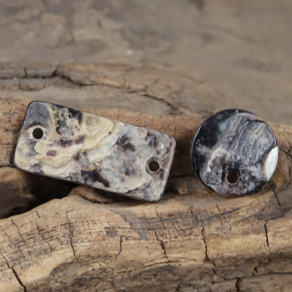 Natural pearl shell buttons with single holes; mottled cream and gray pattern